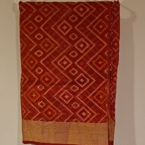 Red and Gold Patterned Fabric or Saree